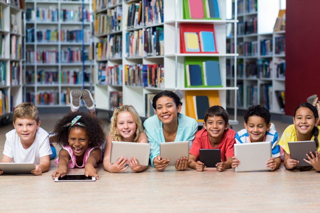 teacher and students reading on tablets