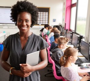 female teacher with students on computers