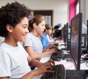 Line Of High School Students Working at Screens In Computer Class