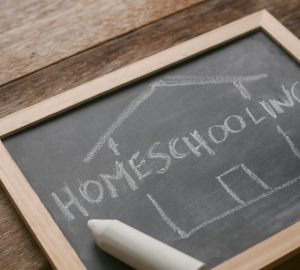 Selective focus of a chalkboard written with Homeschooling on wo