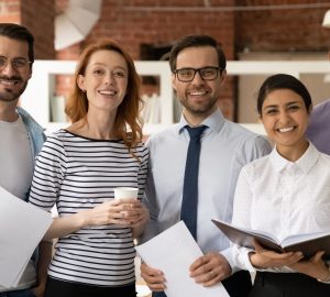 Team of diverse businesspeople multiethnic colleagues standing in modern office smile look at camera. Career advance, leadership, racial equality, professional company corporate staff portrait concept